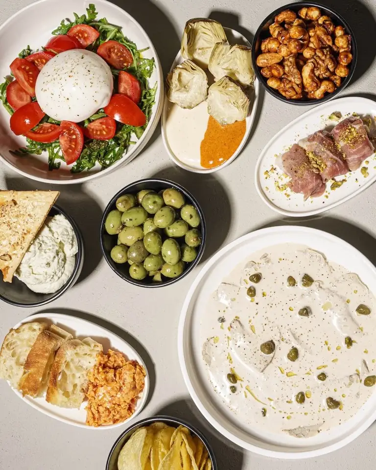 Evening snack spread — burrata, olives, artichokes, spiced cashews